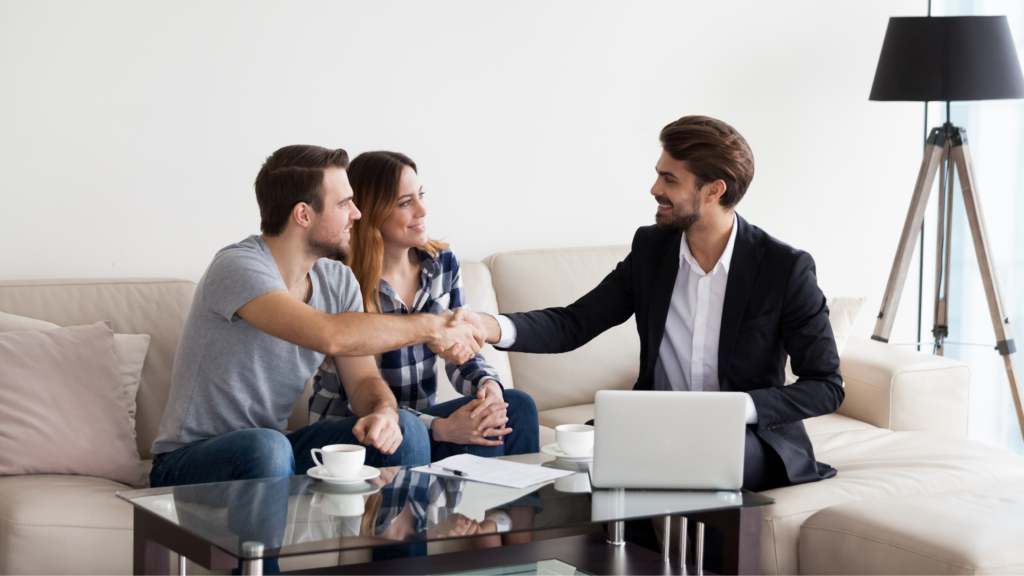 Aspiring real estate agent shaking hands with a client, representing the start of a professional career in real estate