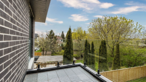 Selling a Home in Spring - A vibrant neighborhood scene showcasing a home for sale with blooming flowers and clear skies