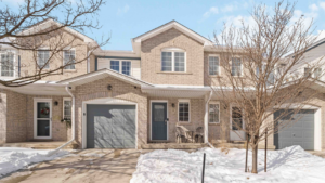 Selling a Home in Winter - A cozy neighborhood scene featuring a home for sale under soft winter skies, surrounded by snow-covered trees and a serene, tranquil atmosphere